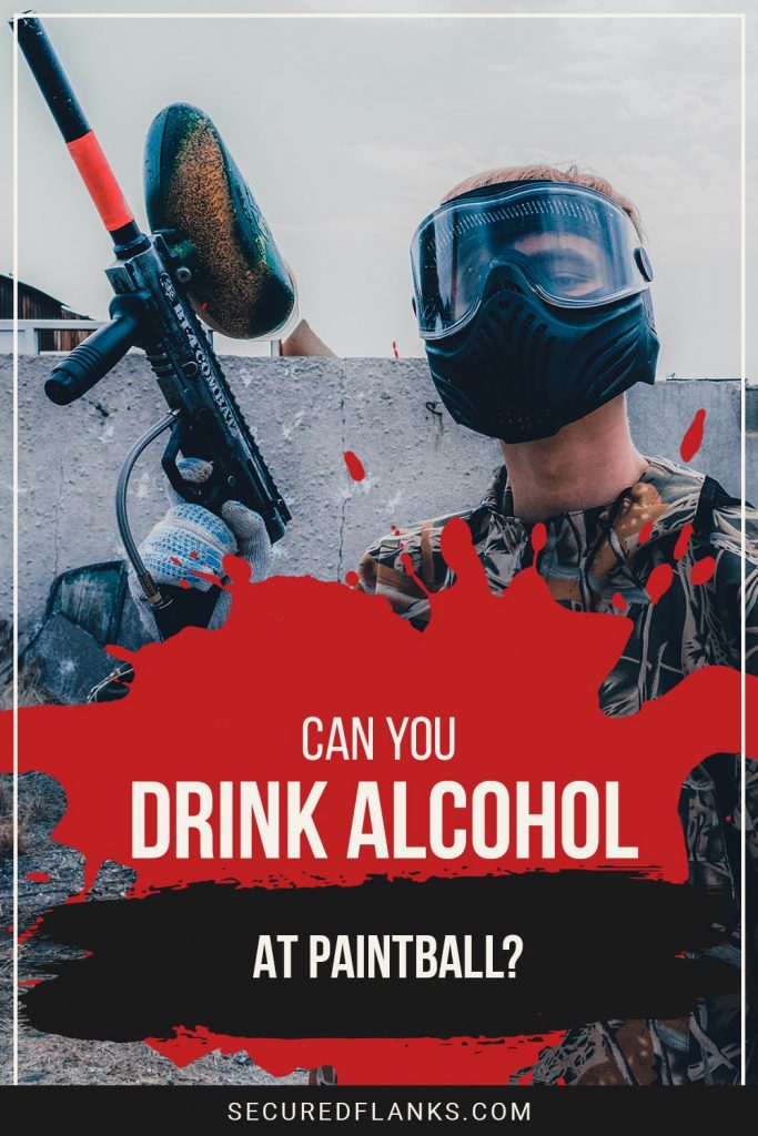 Person standing near a wall with a paintball gun in one hand - Can You Drink Alcohol At Paintball?