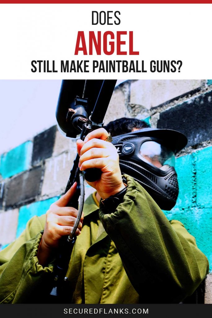 Person in green jacket standing near a wall with a paintball gun in hand - Does Angel Still Make Paintball Guns?