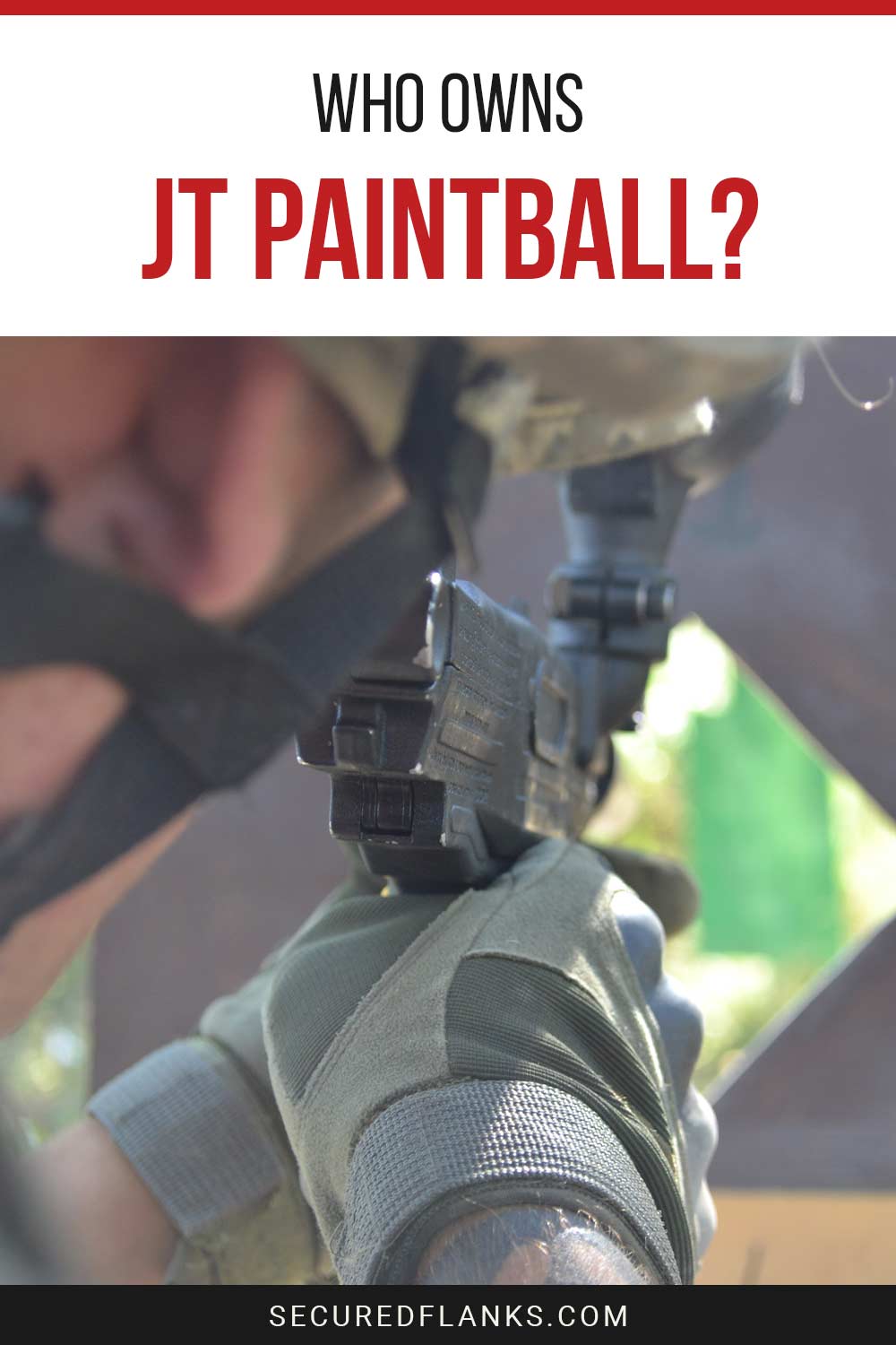 Man wearing gloves and helmet pointing a gun at a target - Who Owns Jt Paintball?