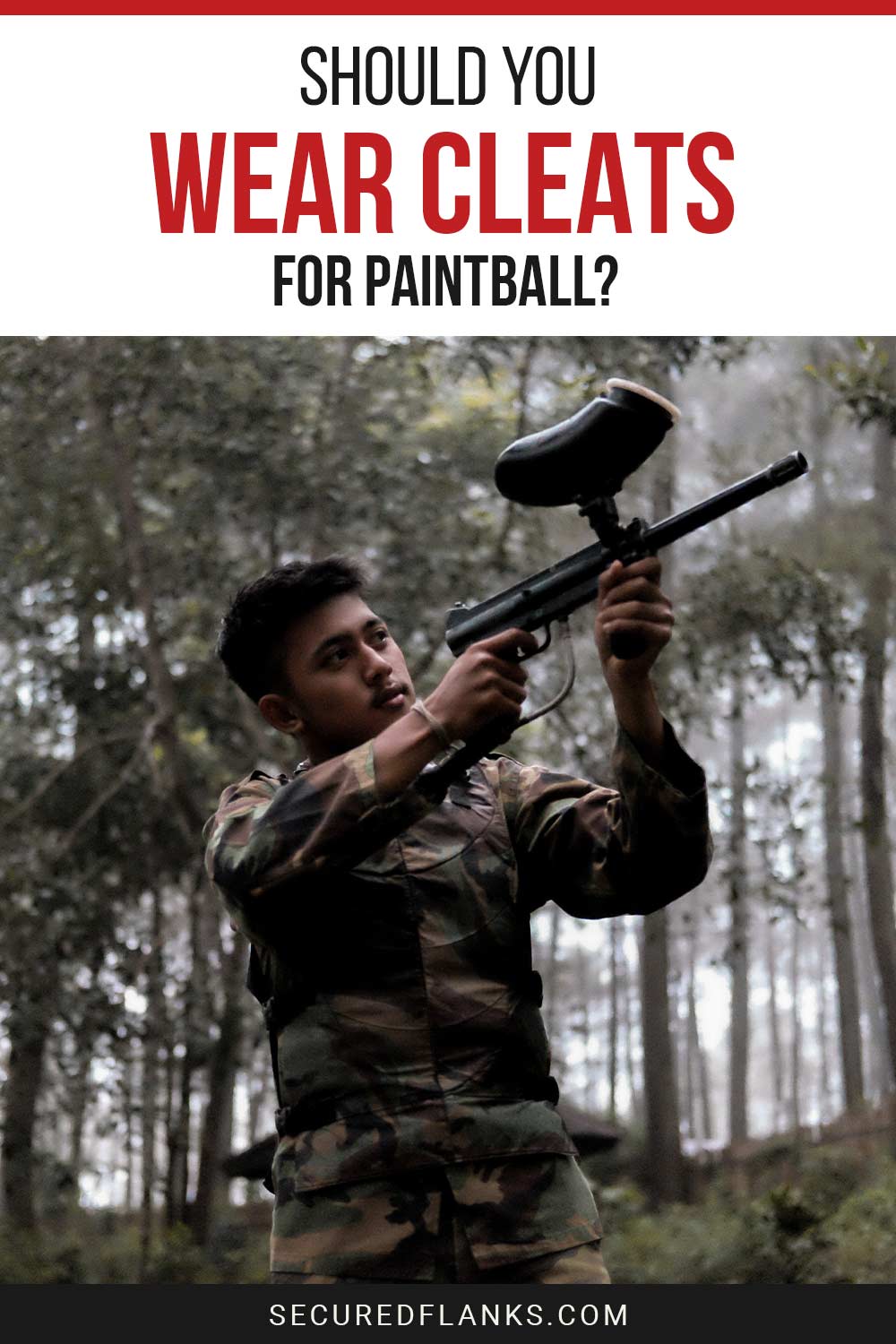 Man in camouflage pointing a paintball gun up - Should You Wear Cleats For Paintball?